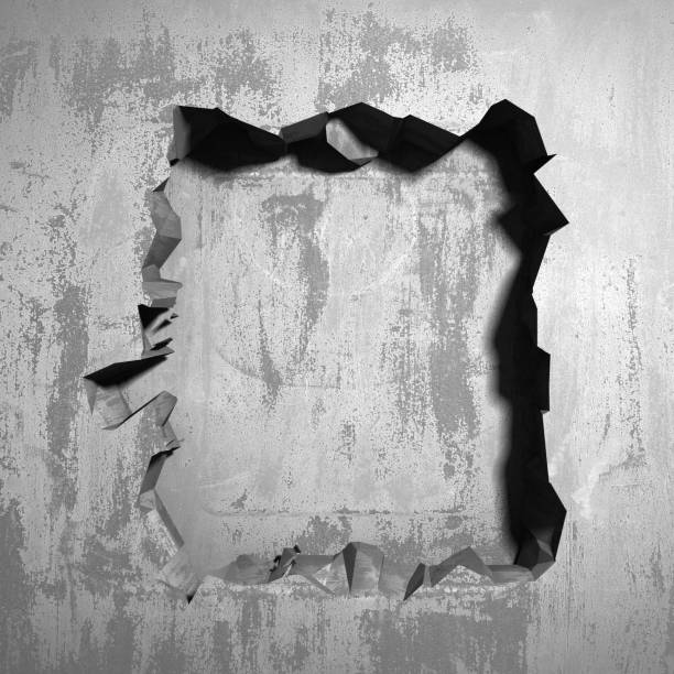 istock Dark cracked broken hole in concrete wall 1135586722