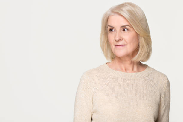 istock Dreamy mature woman looking at copy space isolated on background 1135587076