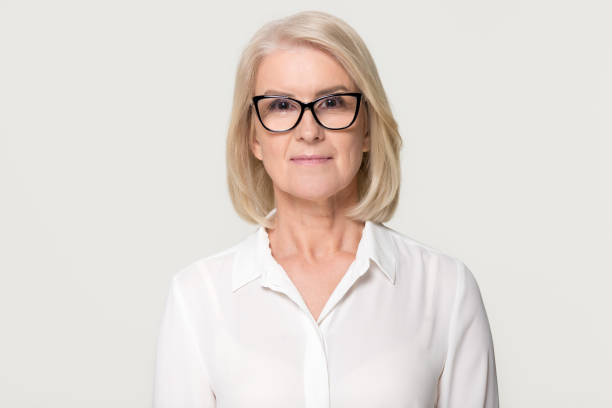 older businesswoman in glasses looking at camera isolated on background - women professor mature adult human face imagens e fotografias de stock