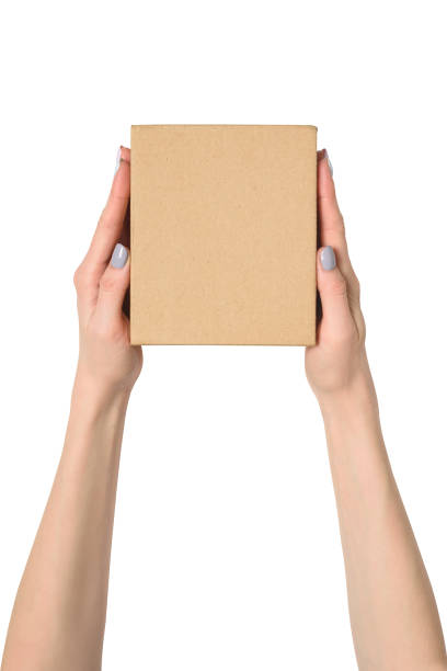 istock Small cardboard box in female hands. Top view. Isolate 1135587922