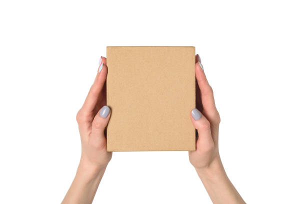 istock Small cardboard box in female hands. Top view. Isolate 1135587924