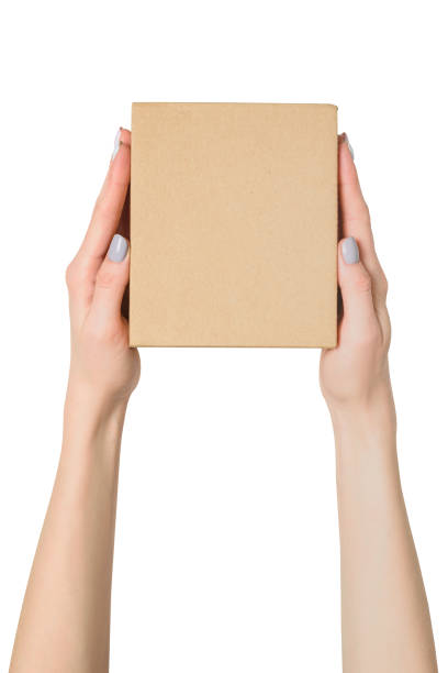 istock Small cardboard box in female hands. Top view. Isolate 1135587938