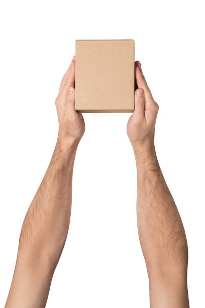 istock Small parcel in male hands. Top view. White table on the background 1135588018