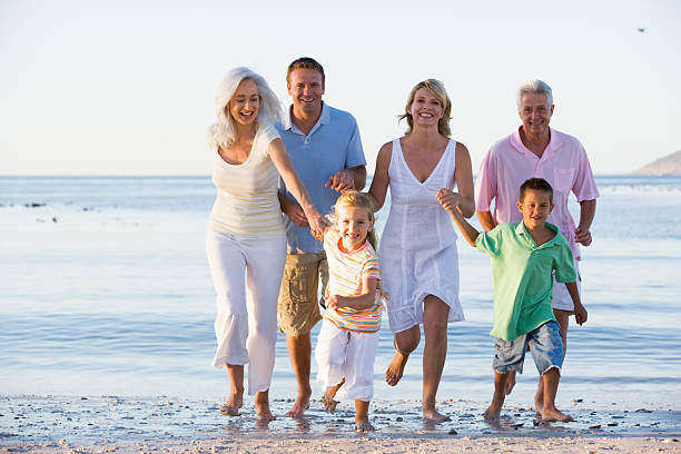 istock Extended family walking on beach 113559165