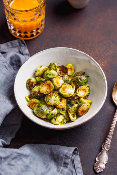 istock View from above on a ceramic bowl with roasted brussel sprouts on a table. The concept of healthy vegetarian eating. 1135592190