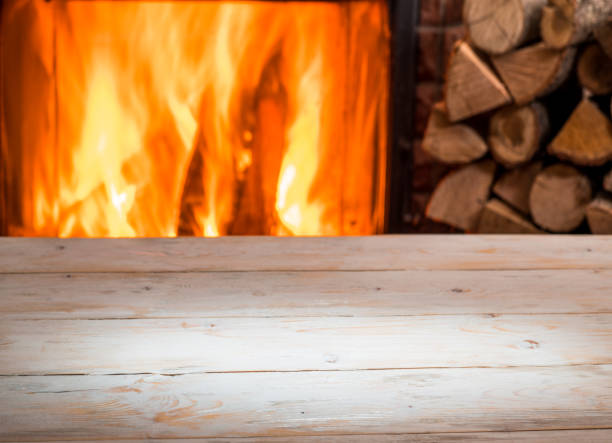 istock Wooden table top and burning warm fire. 1135592371
