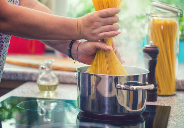 istock Young Women Cooking Spaghetti 1135595169