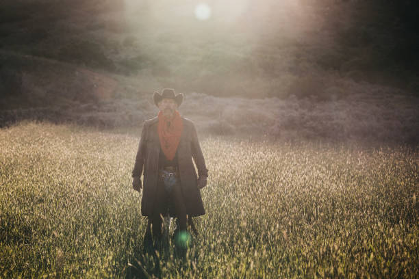 istock A cowboy walking in a field. 1135595484