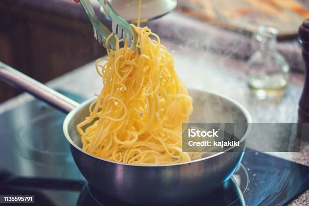 Preparing Spaghetti With Vongole Stock Photo - Download Image Now - Pasta, Spaghetti, Cooking