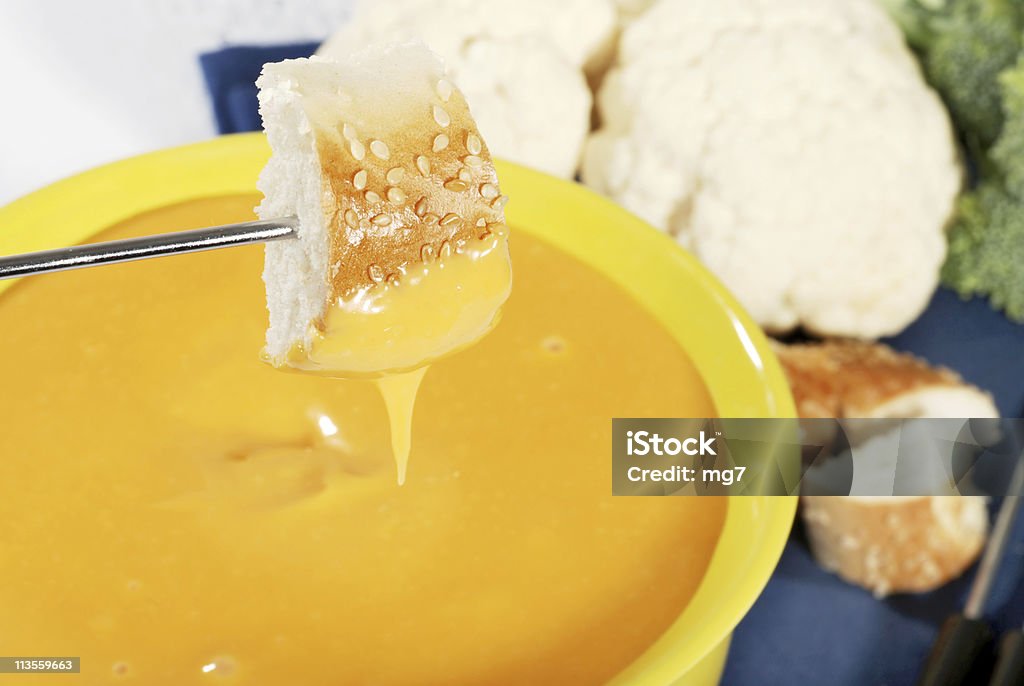 closeup of bread dipped in cheese  Cheese Fondue Stock Photo