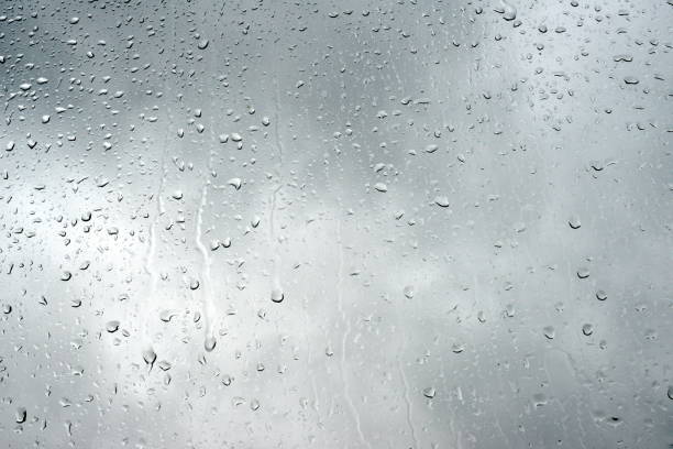 istock Close up on raindrops on a window glass on a dramatic cloudy sky. 1135598989