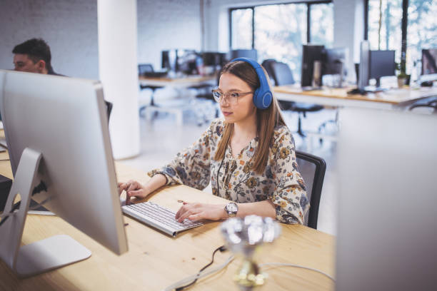 istock Lovely female programmer working with colleagues at the office 1135599627