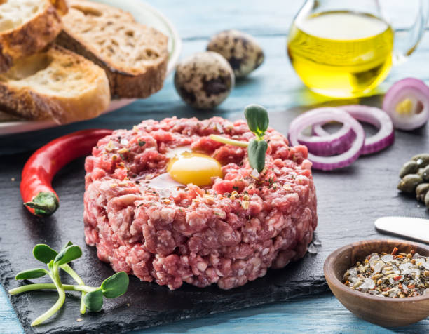 istock Steak tartare served with raw quail egg yolk, capers and bread. 1135599658