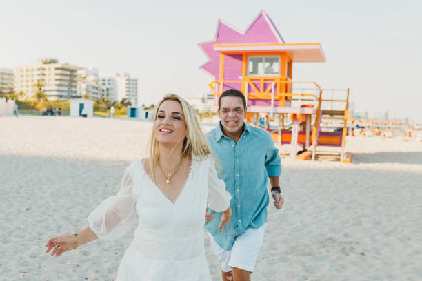 istock Couple running on the beach 1135600300