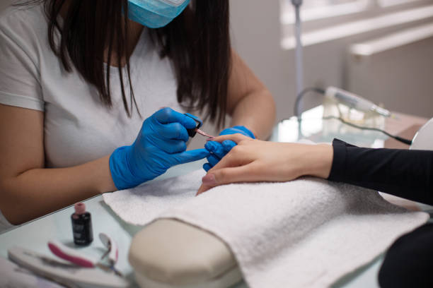 istock Young woman getting her nails done 1135602150