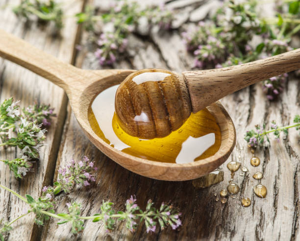 istock Herbal honey pouring into the wooden spoon. 1135602309