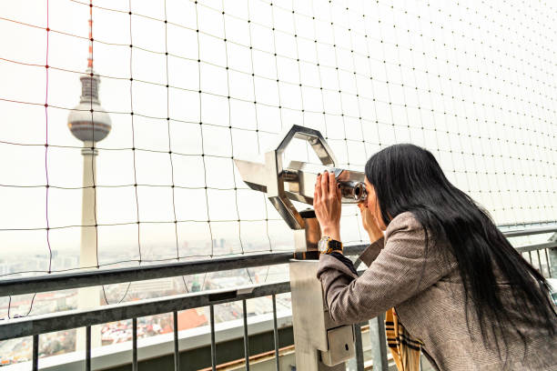 istock Girl looks at Berlin TV tower from binoculars 1135603361