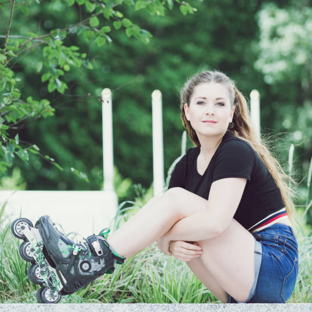 istock Young woman riding roller skates 1135603526