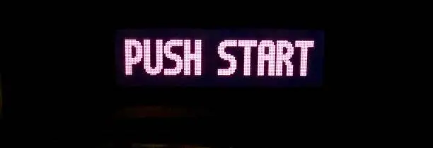 Close up view of the words push start on the screen of an old retro video game