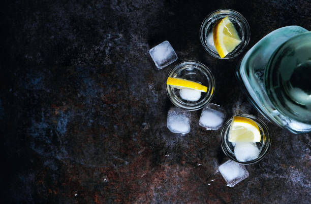 istock Vodka in glasses with lemon and ice. On the black stone table. Copyspace. 1135608983