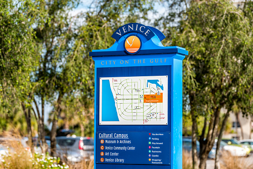 Venice, USA - April 29, 2018: Closeup of map information sign in small Florida retirement city or village with colorful blue color in gulf of Mexico on street
