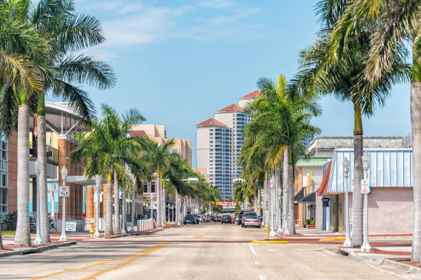 City town street during sunny day in Florida gulf of mexico coast for shopping and palm trees Fort Myers, USA - April 29, 2018: City town street during sunny day in Florida gulf of mexico coast for shopping and palm trees fort myers stock pictures, royalty-free photos & images