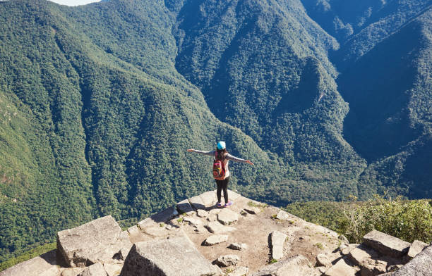 istock Woman enjoing view from mountain cliff 1135611949