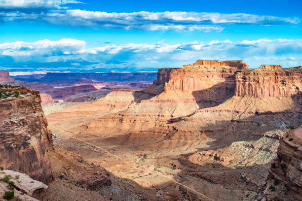 Shafer Canyon in Canyonlands National Park Utah USA Stock photograph of Shafer Canyon in Canyonlands National Park and the La Sal Mountains in the distance, Utah, USA at sunset. la sal mountains stock pictures, royalty-free photos & images