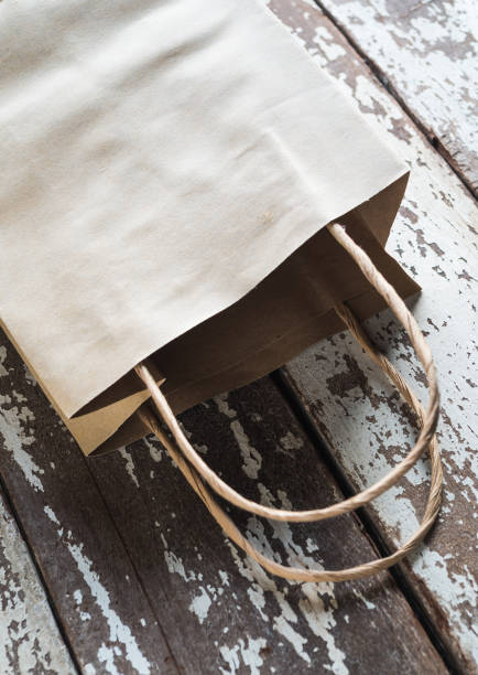 istock brown paper bag on wooden table 1135613013