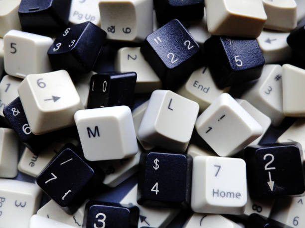 Black and white computer keyboard keys, mostly numeric with ML (Machine learning) buttons at the front. Concept of unstructured big data that need to be sorted ready to be consumed by ML or deep learning. stock photo