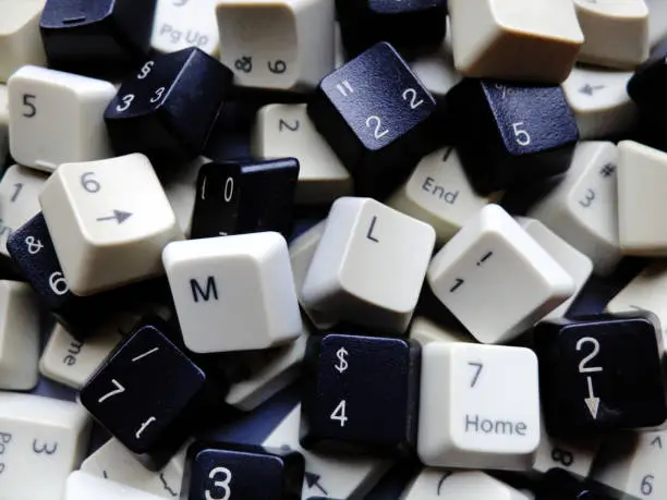 Black and white computer keyboard keys, mostly numeric with ML (Machine learning) buttons at the front. Concept of unstructured big data that need to be sorted ready to be consumed by ML or deep learning.