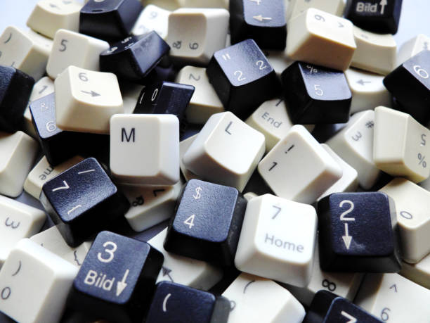 Black and white computer keyboard keys, mostly numeric with ML (Machine learning) buttons at the front. Concept of unstructured big data that need to be sorted ready to be consumed by ML or deep learning. stock photo