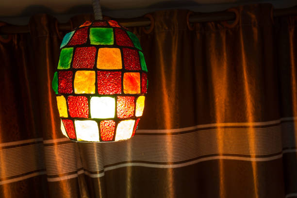 Colorful lamps lanterns hanging on the ceiling. Elegant modern shape lamp