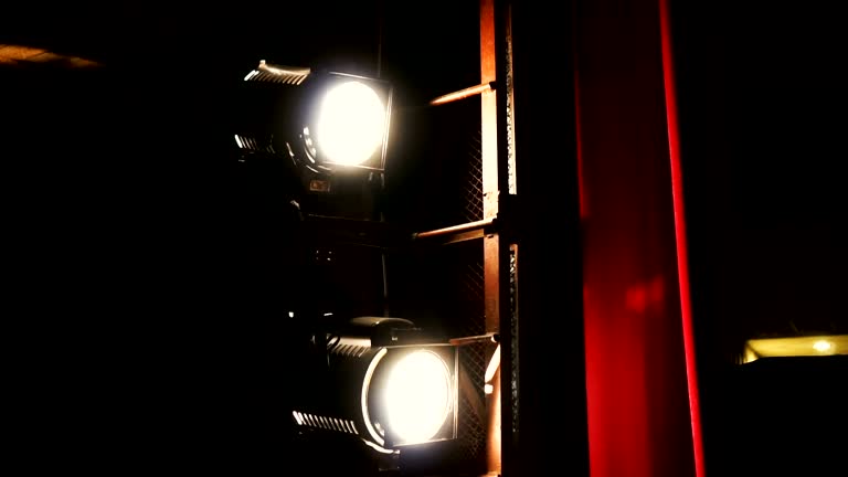 Vintage theater spot light on red curtain