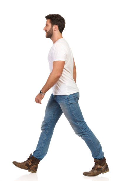 istock Walking Man In White T-shirt, Jeans And Boots 1135632705
