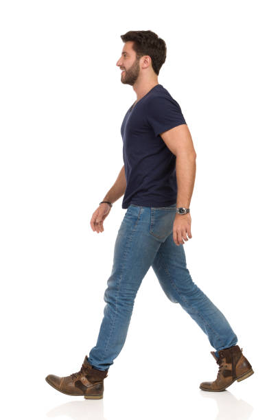 istock Walking Man In Blue T-shirt, Jeans And Boots 1135632714