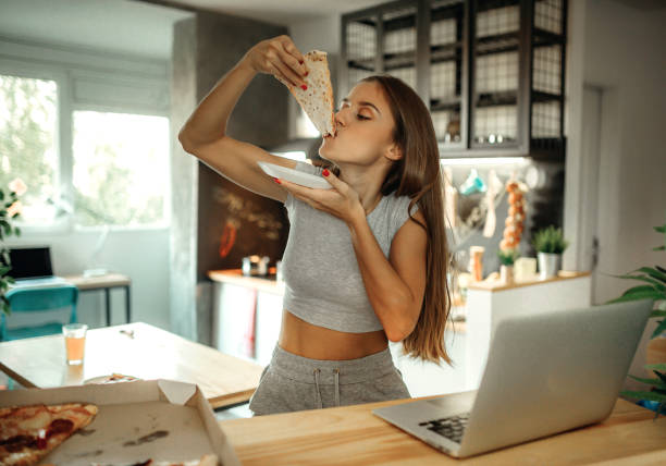 istock Woman eating pizza 1135634051
