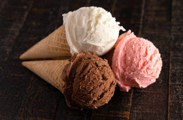 istock Three Classic Flavors of Ice Cream on a Wooden Table 1135634906