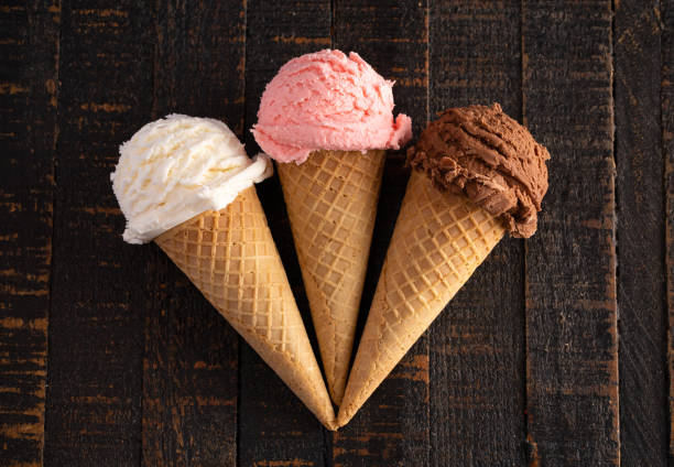 istock Three Classic Flavors of Ice Cream on a Wooden Table 1135635614