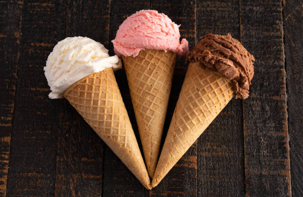 istock Three Classic Flavors of Ice Cream on a Wooden Table 1135635616