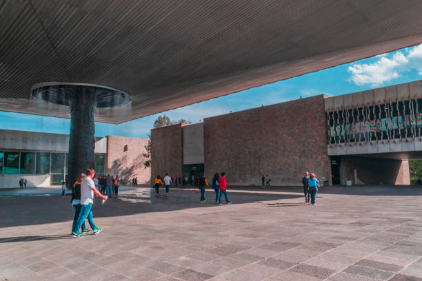 Mexico, Mexico city, December 27 2018: Full shot of the main yard in the Anthropology museum with people walking around the main fountain