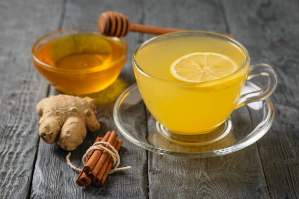istock A restorative vitamin drink made from ginger root and citrus on a black table. 1135654946