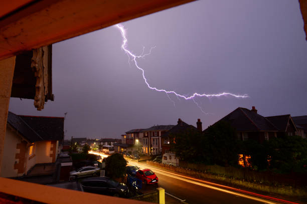 Light Trails and Lightning Over Rooftops stock photo