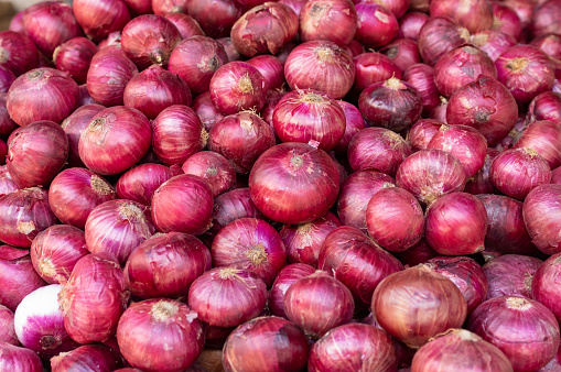 A pile of onions at the vegetable market.