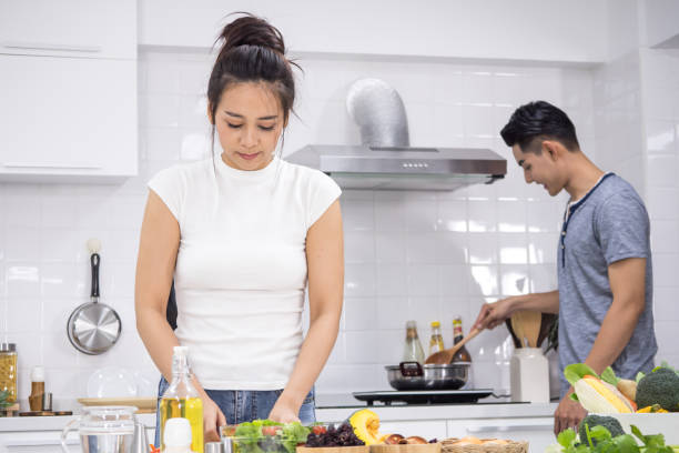 istock Couple preparing food for dinner in kitchen at home 1135660651