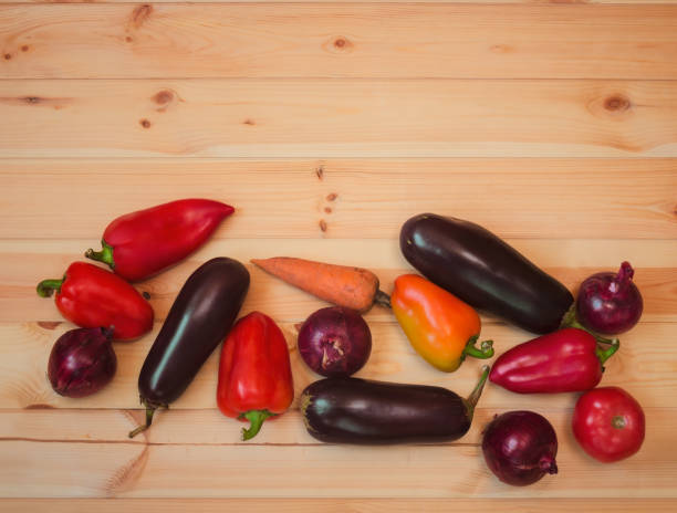 istock Border made of assorted fresh vegetables on wooden background. 1135663636
