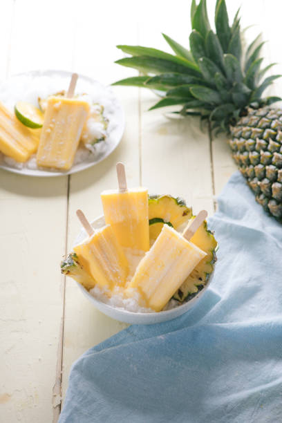 istock Homemade ice cream or popsicles from pineapple decorated. Top view. Frozen fruit pulp. Summer sweets 1135665511