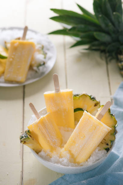 istock Homemade ice cream or popsicles from pineapple decorated. Top view. Frozen fruit pulp. Summer sweets 1135665574
