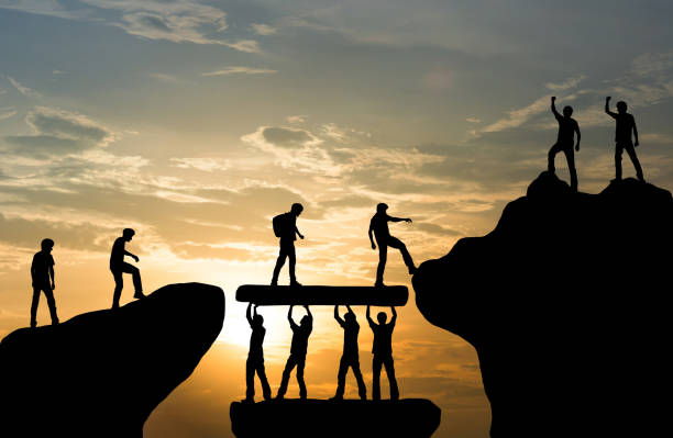 Group of people on peak mountain climbing helping team work , travel trekking success business concept Group of people on peak mountain climbing helping team work , travel trekking success business concept trust stock pictures, royalty-free photos & images