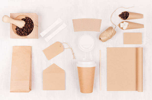 istock Decorative background for restaurant and coffee shop - blank paper cup, notebook, label, packet, coffee beans, sugar, mortar on white wood board. 1135672054